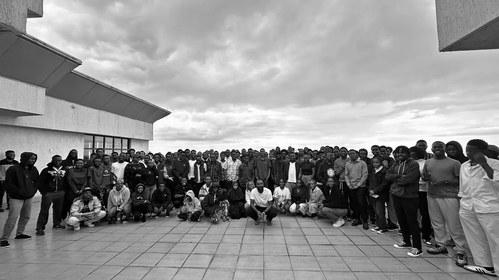 A large group of builders gathered together on a rooftop