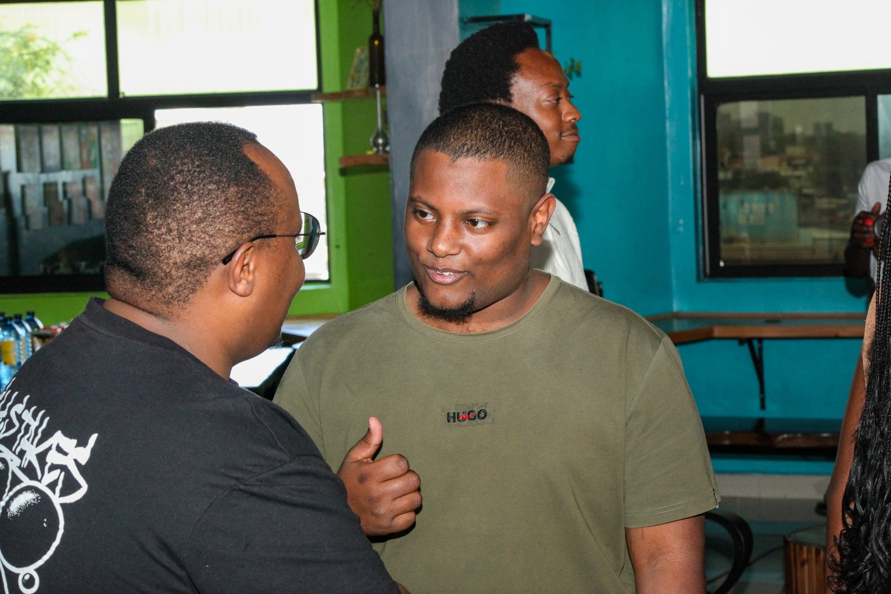 Two men in conversation, one gesturing with his hand