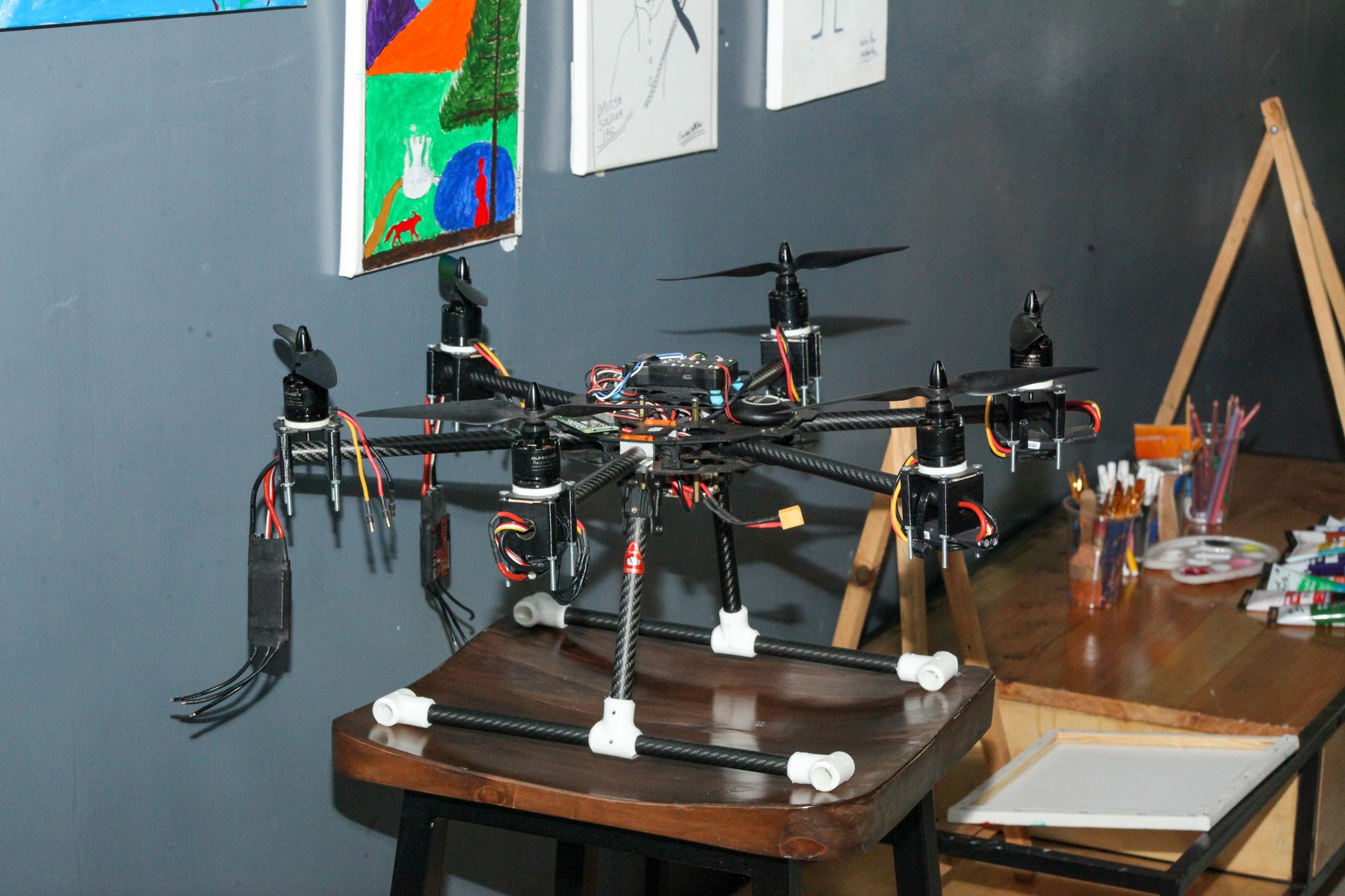 A drone prototype and electronics on a worktable