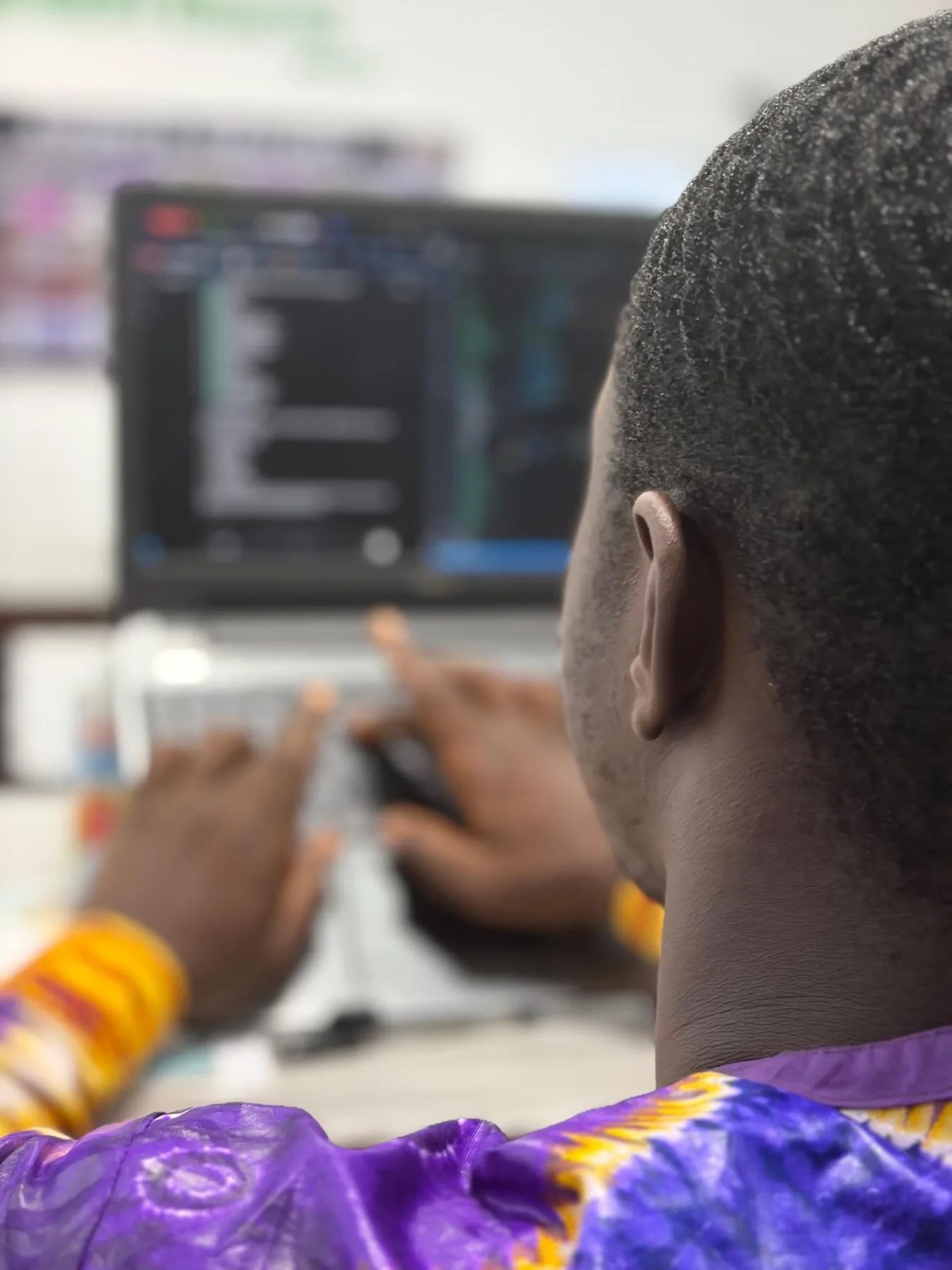 A builder typing code on a laptop